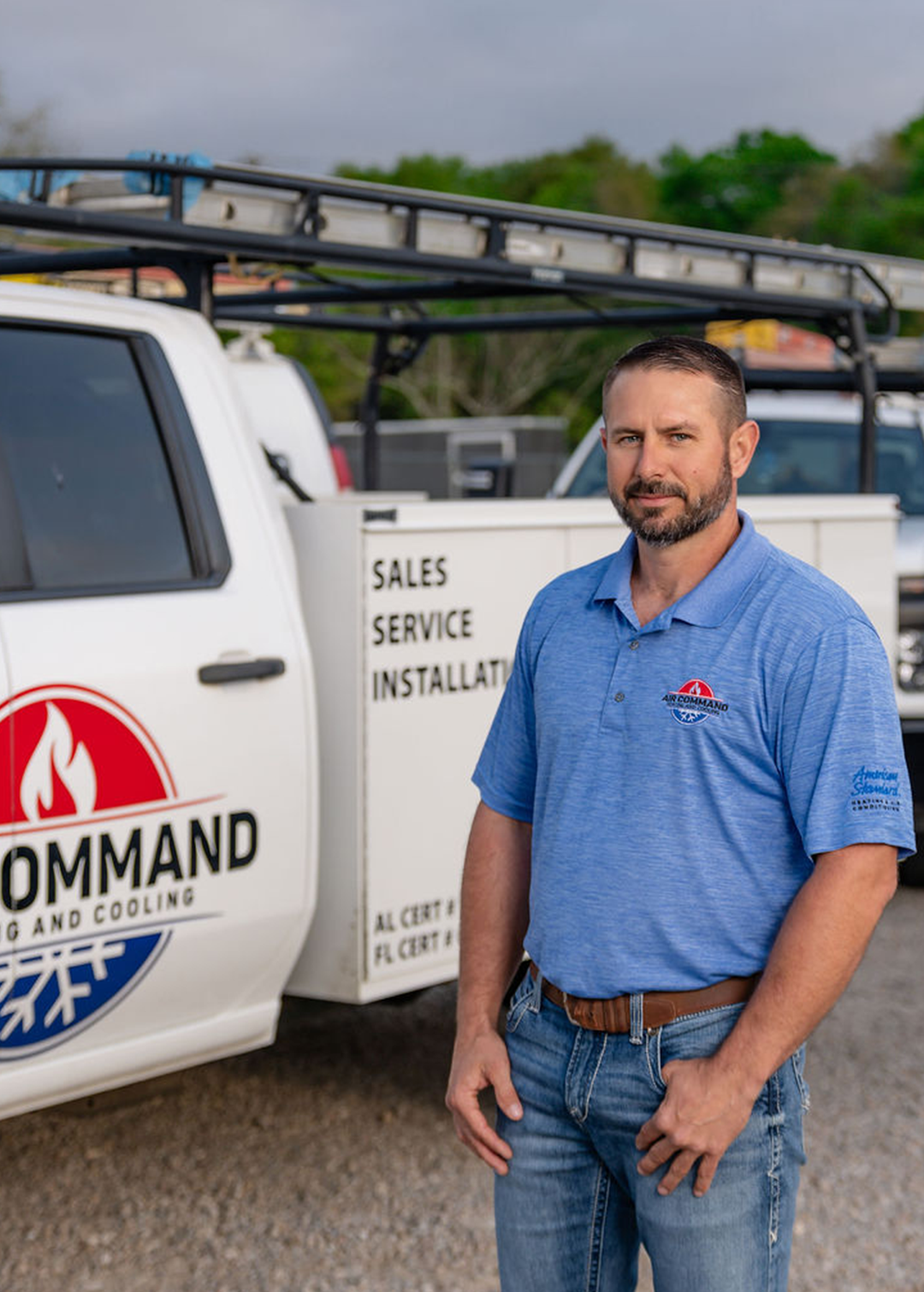 Brandon Commander, Installation Crew Member at Air Command Heating and Cooling, standing in front of company service trucks in Hartford, AL.
